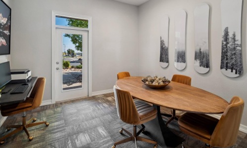 business center with computer desk, a table and chairs