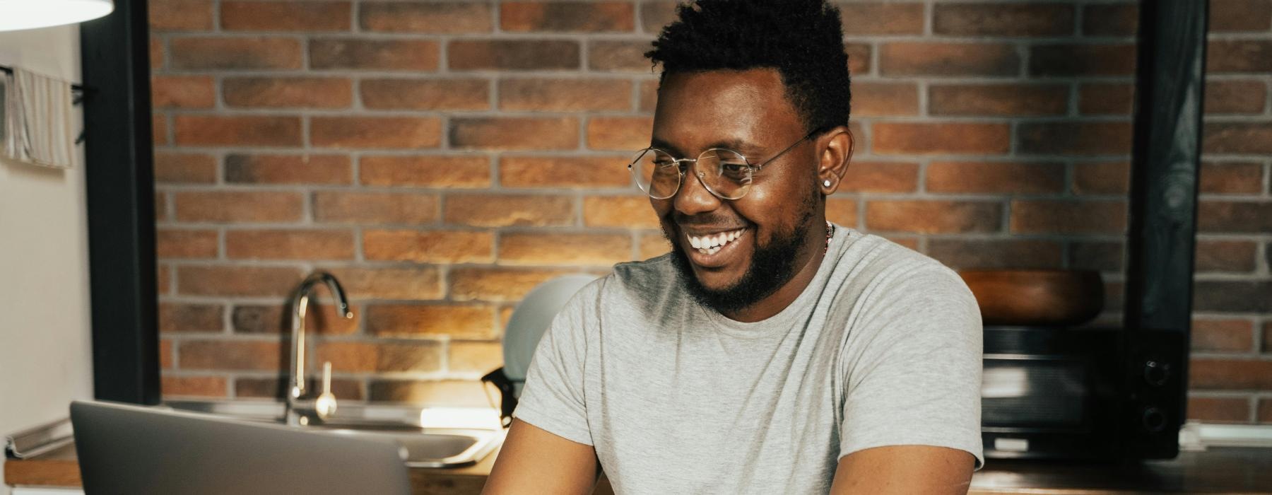 a man sitting at a table with a laptop