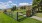 fenced in dog park with a wooden gate