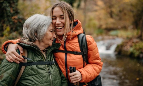 a couple of women smiling while hiking