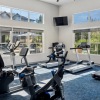 fitness center with rows of treadmills and modern style flooring
