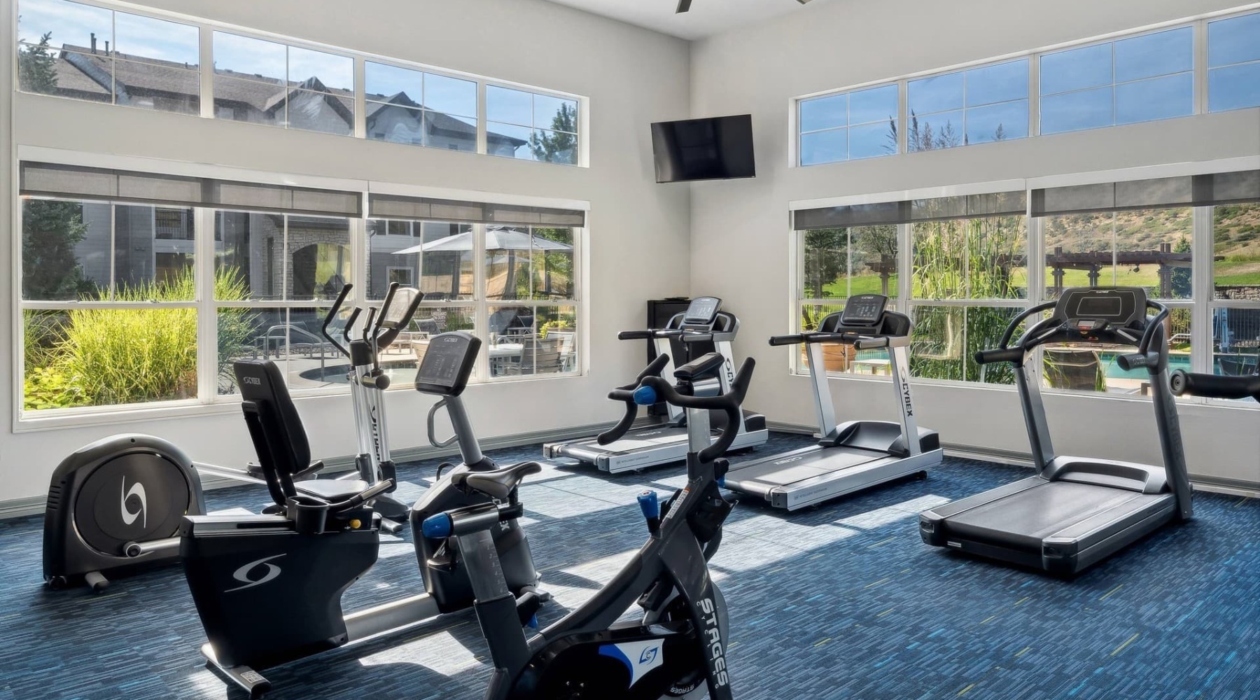fitness center with rows of treadmills and modern style flooring
